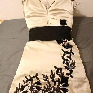 Satin off white cocktail dress with black lace embroidery and black belt